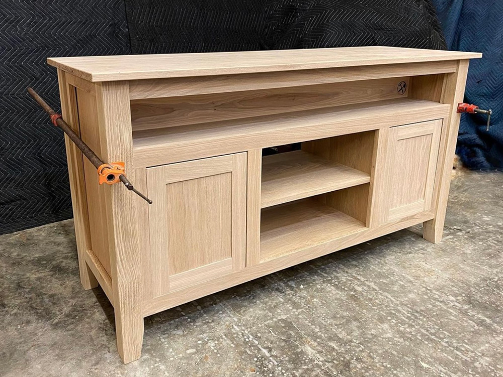 Medium dark wood entertainment stand before stain